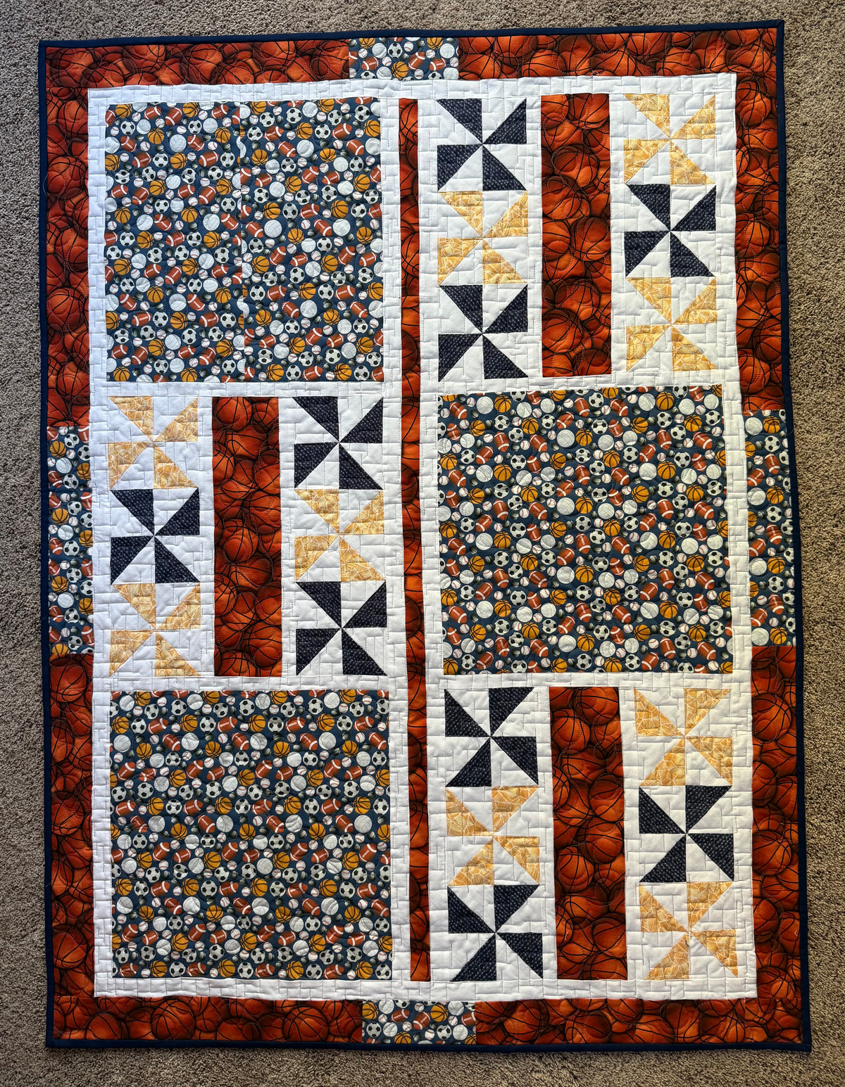 Patchwork quilt with balls for various sports