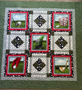 Handmade golf quilt laid flat showing full patchwork design