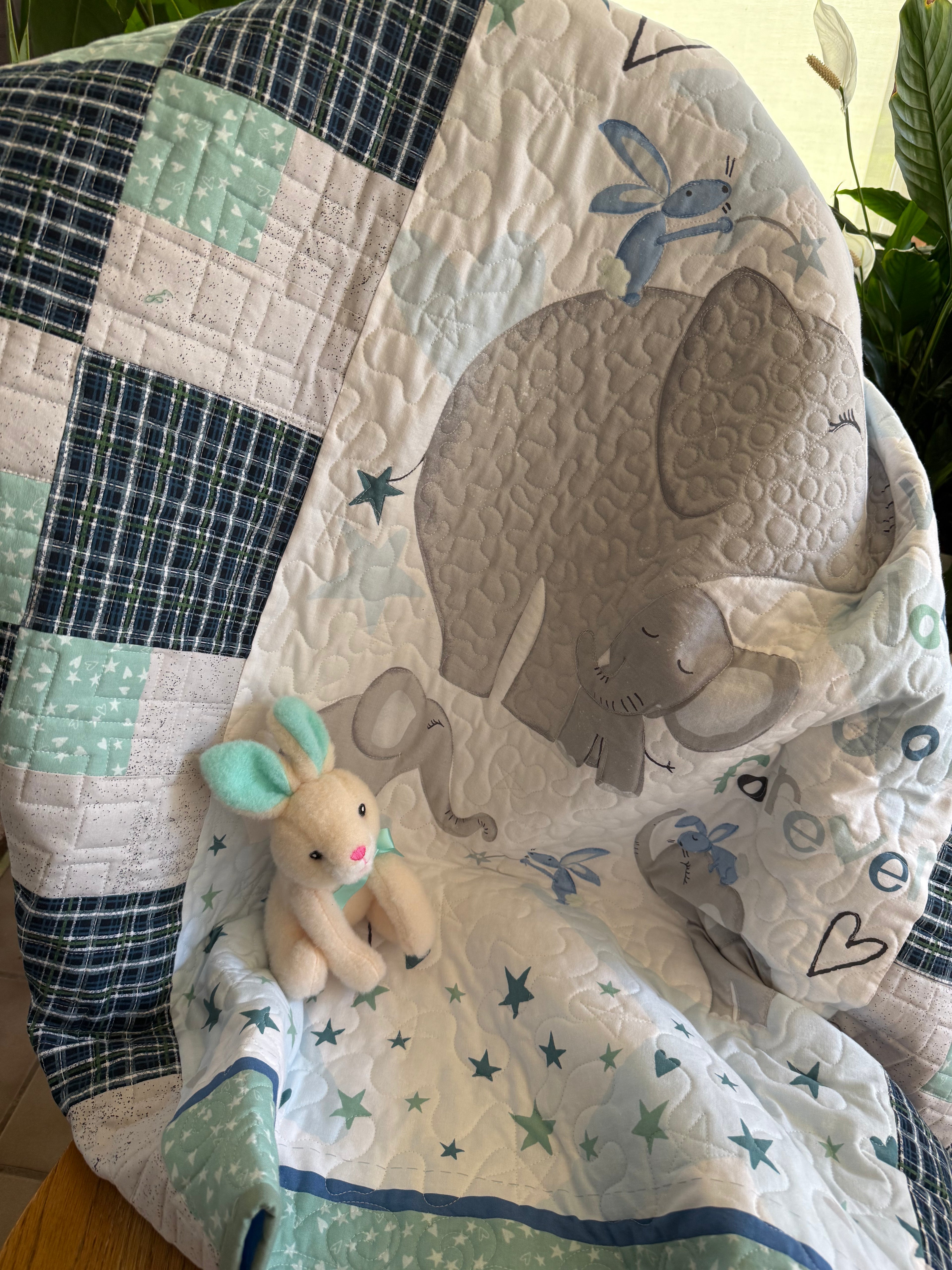 Handmade baby quilt with elephant and blue and green patchwork