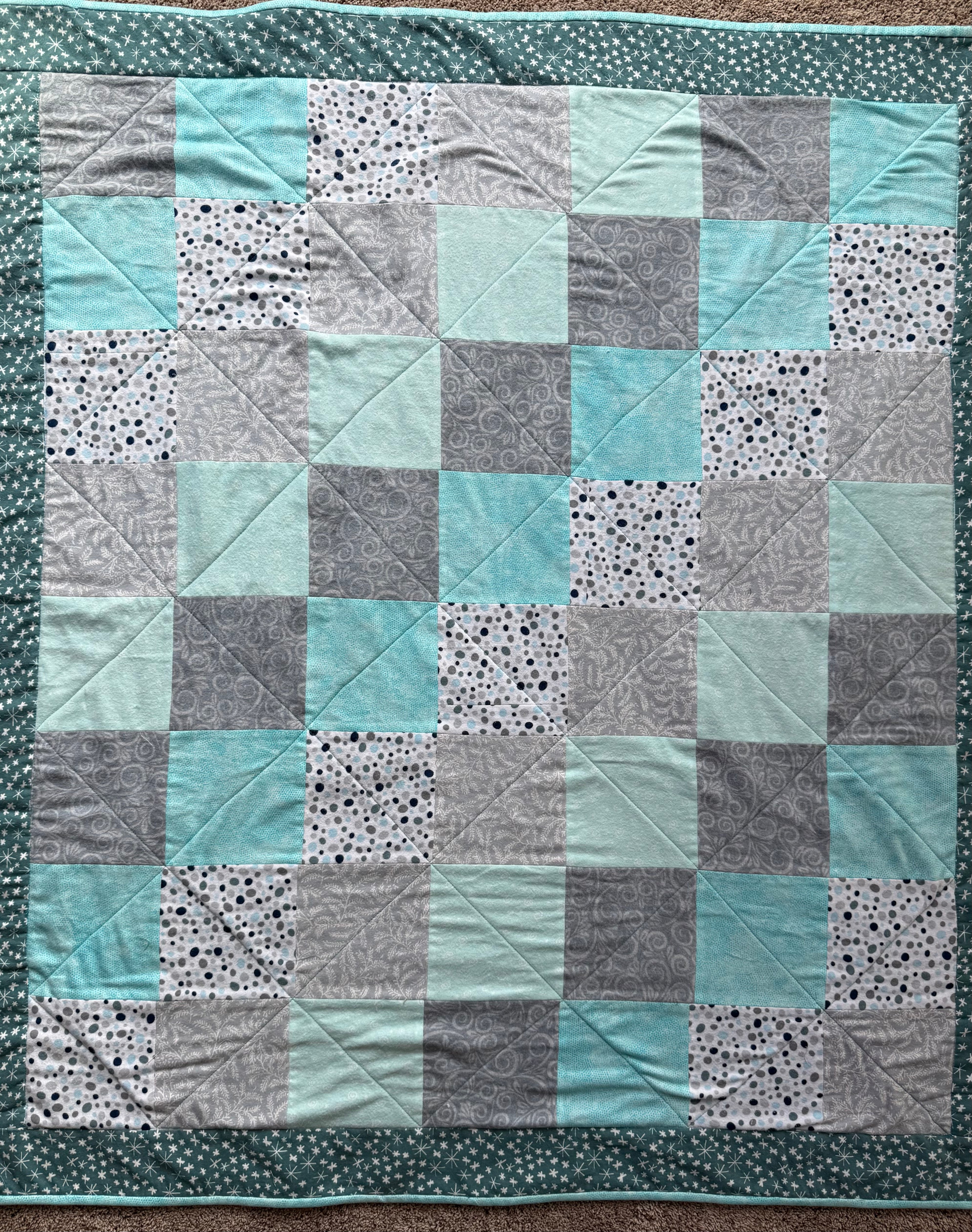 Handmade flannel scrap quilt in mixed prints, cozy and colorful, by Oak & Thread Quilts