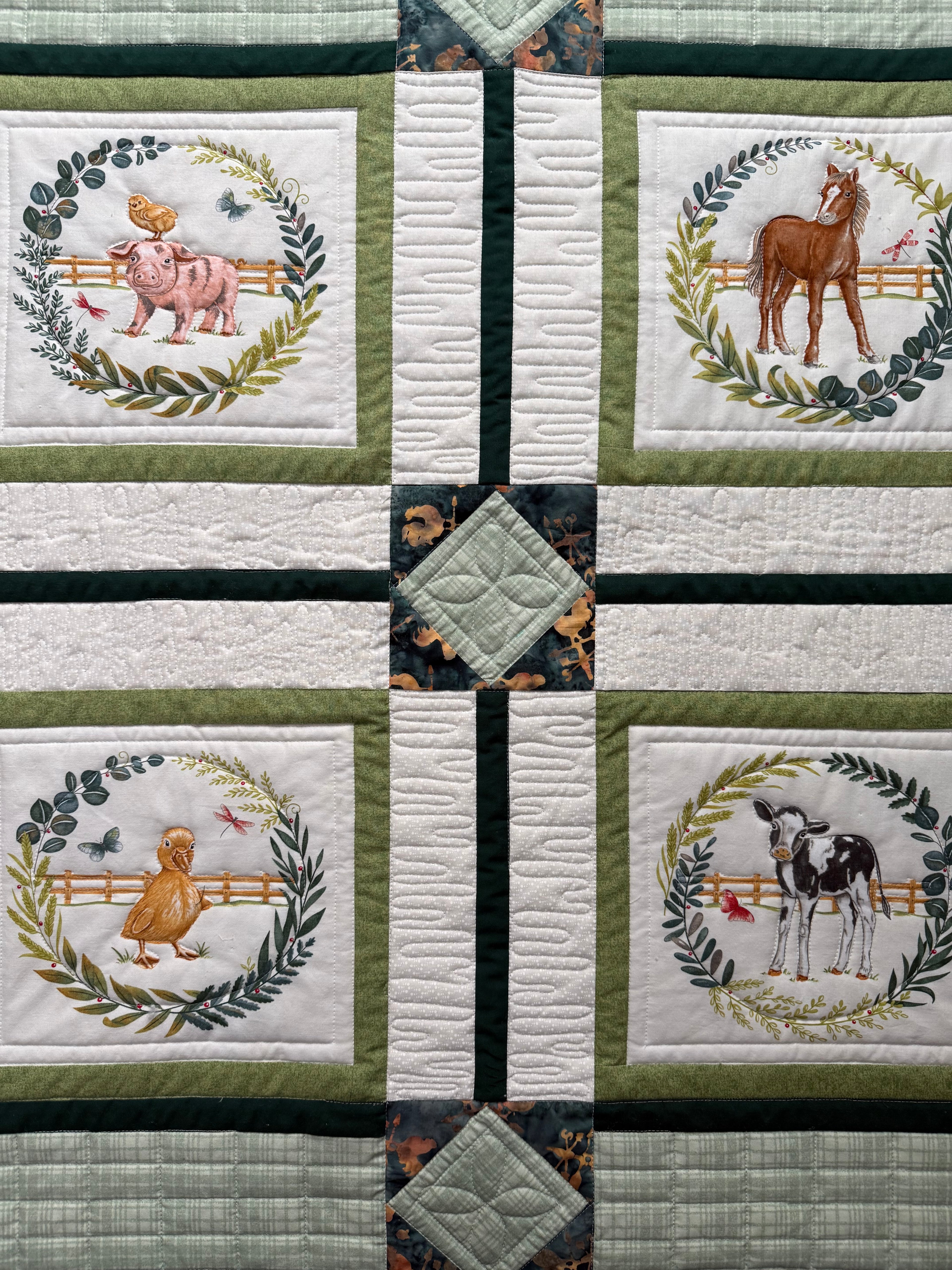 Handmade baby quilt with close up of quilting