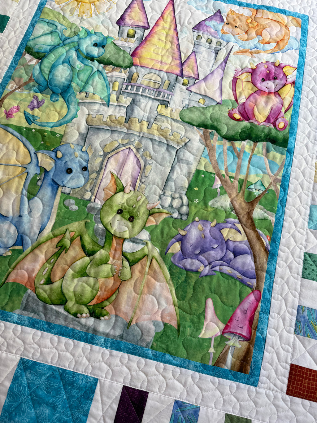 Handmade baby dragon quilt with colorful dragon design, soft cotton fabric, made by Oak & Thread Quilts