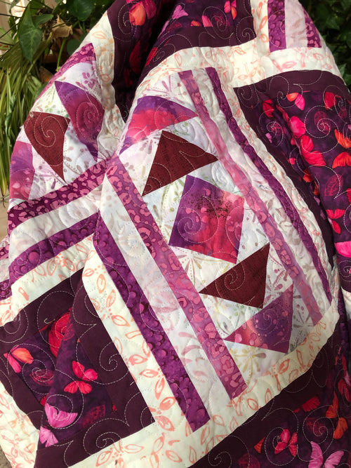 Handmade batik quilt in pink and white with butterflies