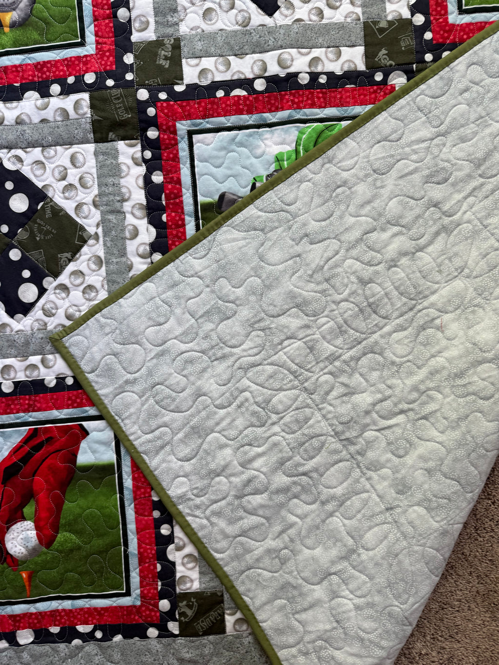Handmade golf quilt folded to show texture and backing