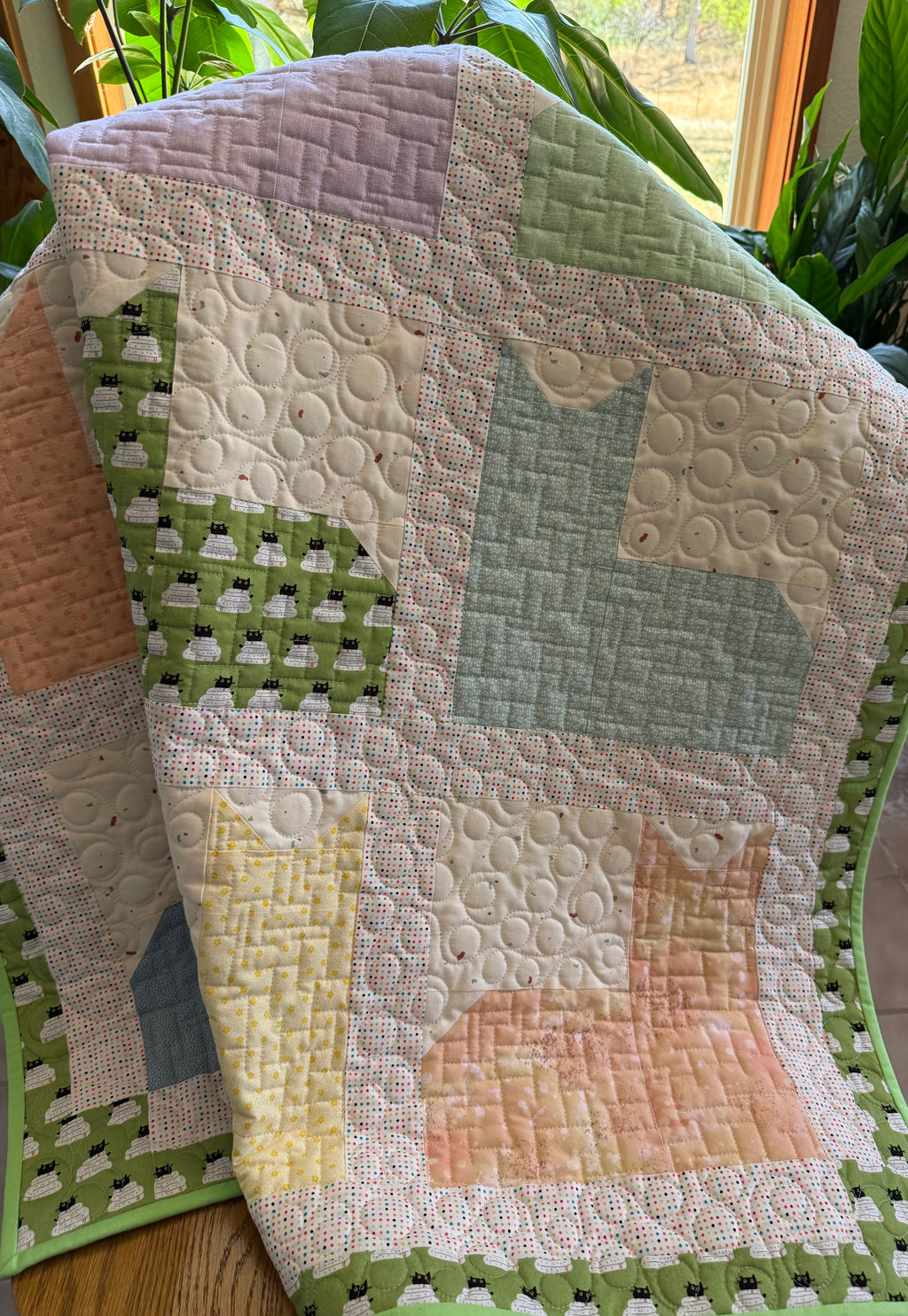 Kitty quilt draped over a chair