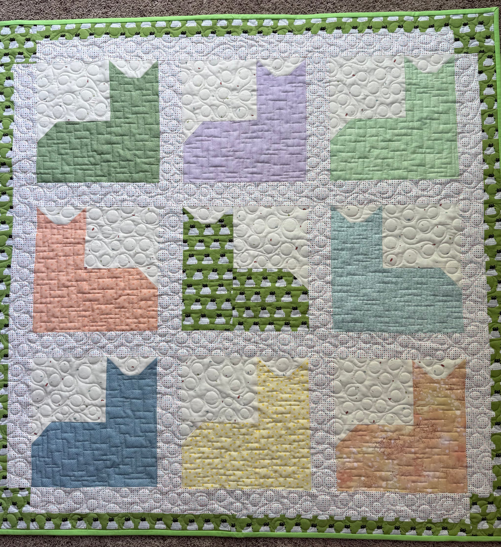 Handmade cat quilt in various pastel colors