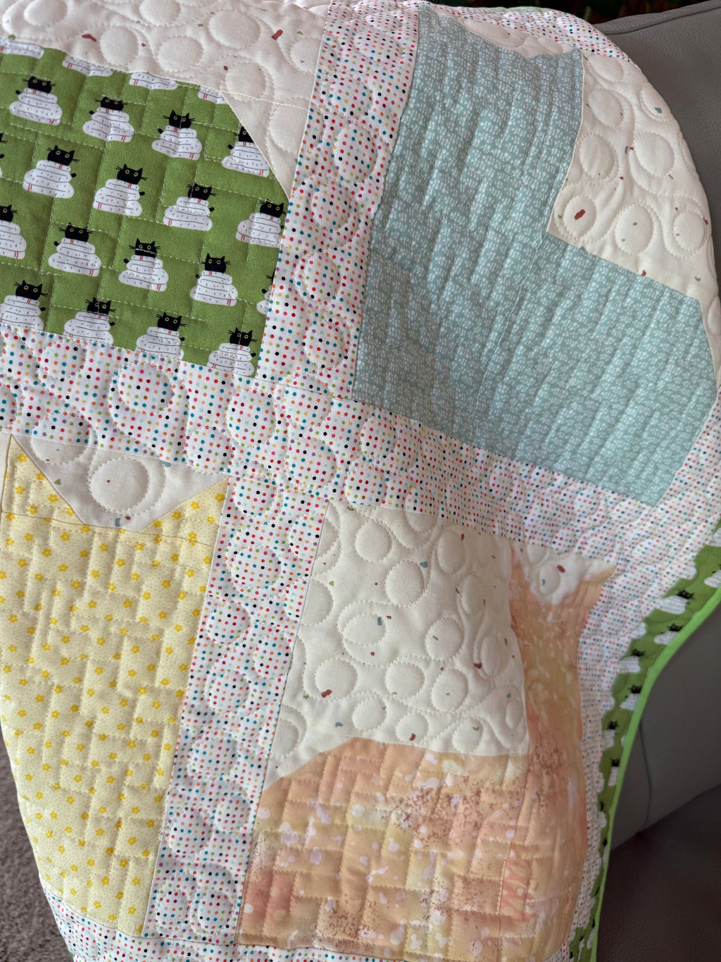 Close up of cats on handmade quilt