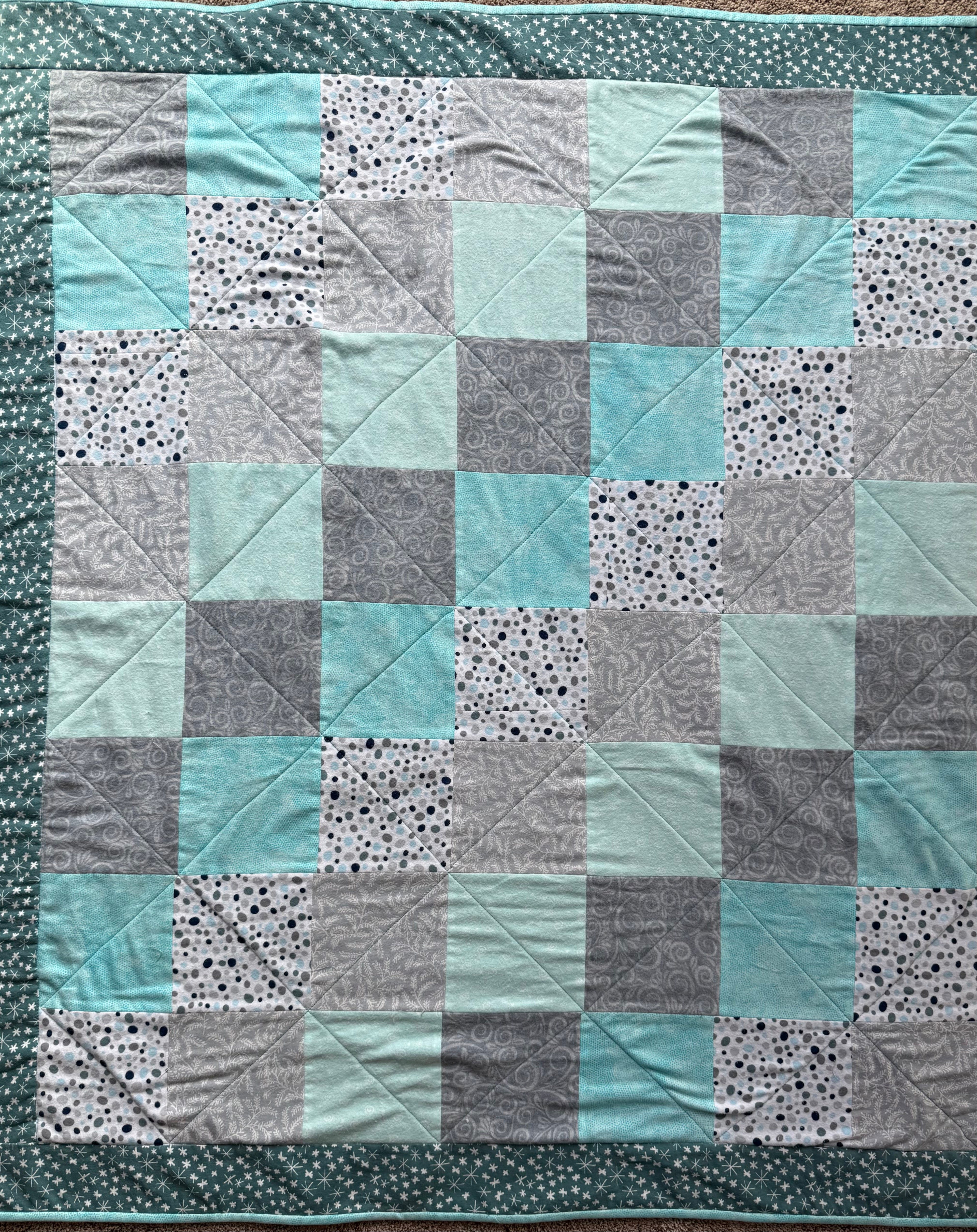 Handmade flannel scrap quilt in mixed prints, cozy and colorful, by Oak & Thread Quilts