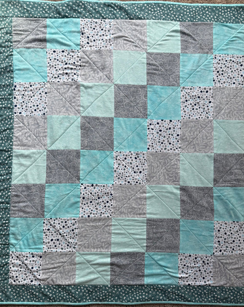 Handmade flannel scrap quilt in mixed prints, cozy and colorful, by Oak & Thread Quilts