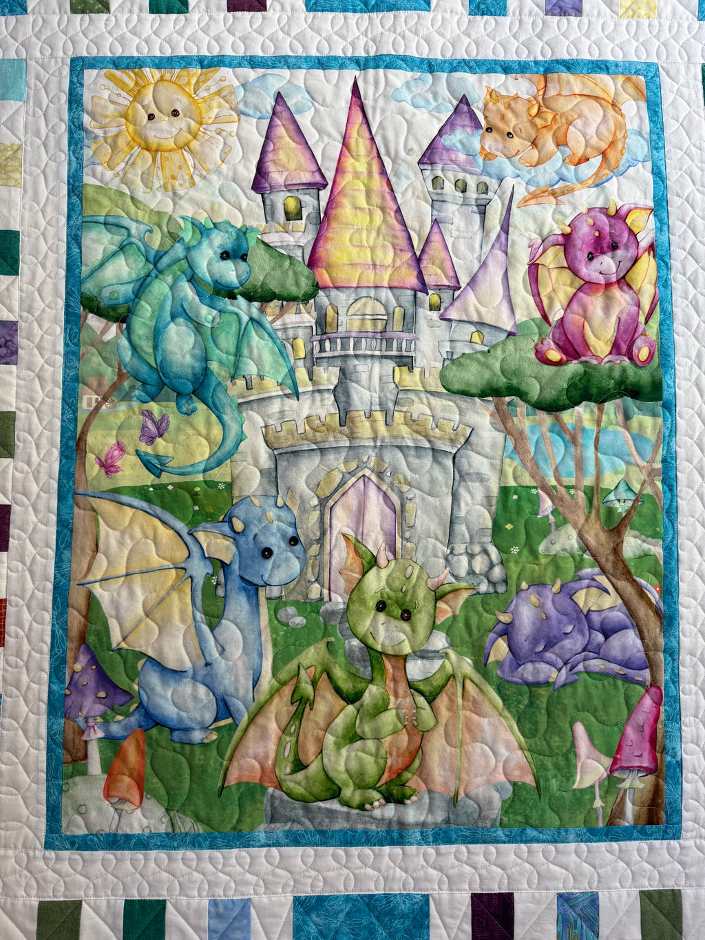 Handmade baby dragon quilt with colorful dragon design, soft cotton fabric, made by Oak & Thread Quilts