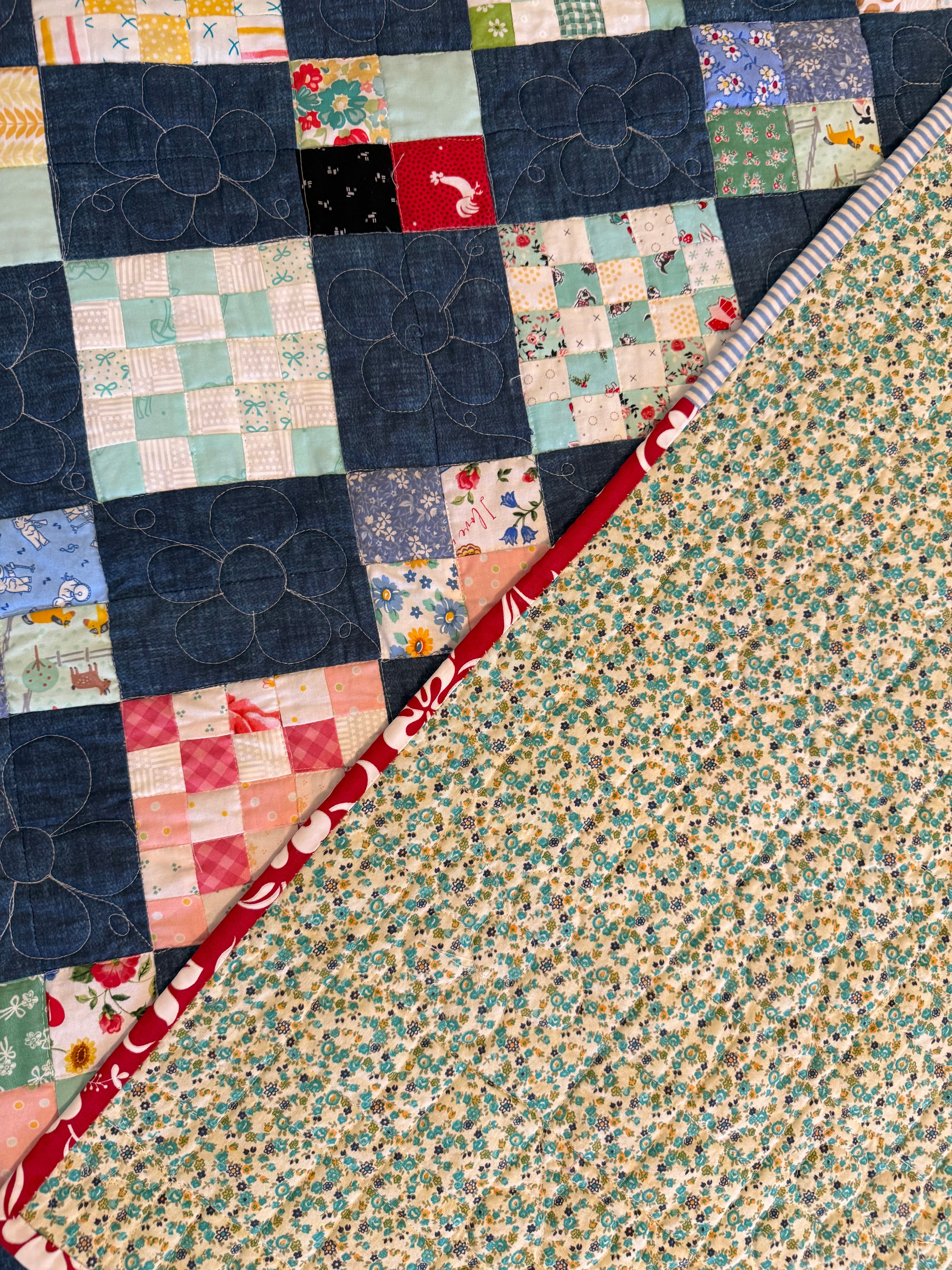 Handmade checkerboard quilt folded to show texture and backing