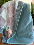 Handmade flannel scrap quilt in mixed prints, cozy and colorful, by Oak & Thread Quilts