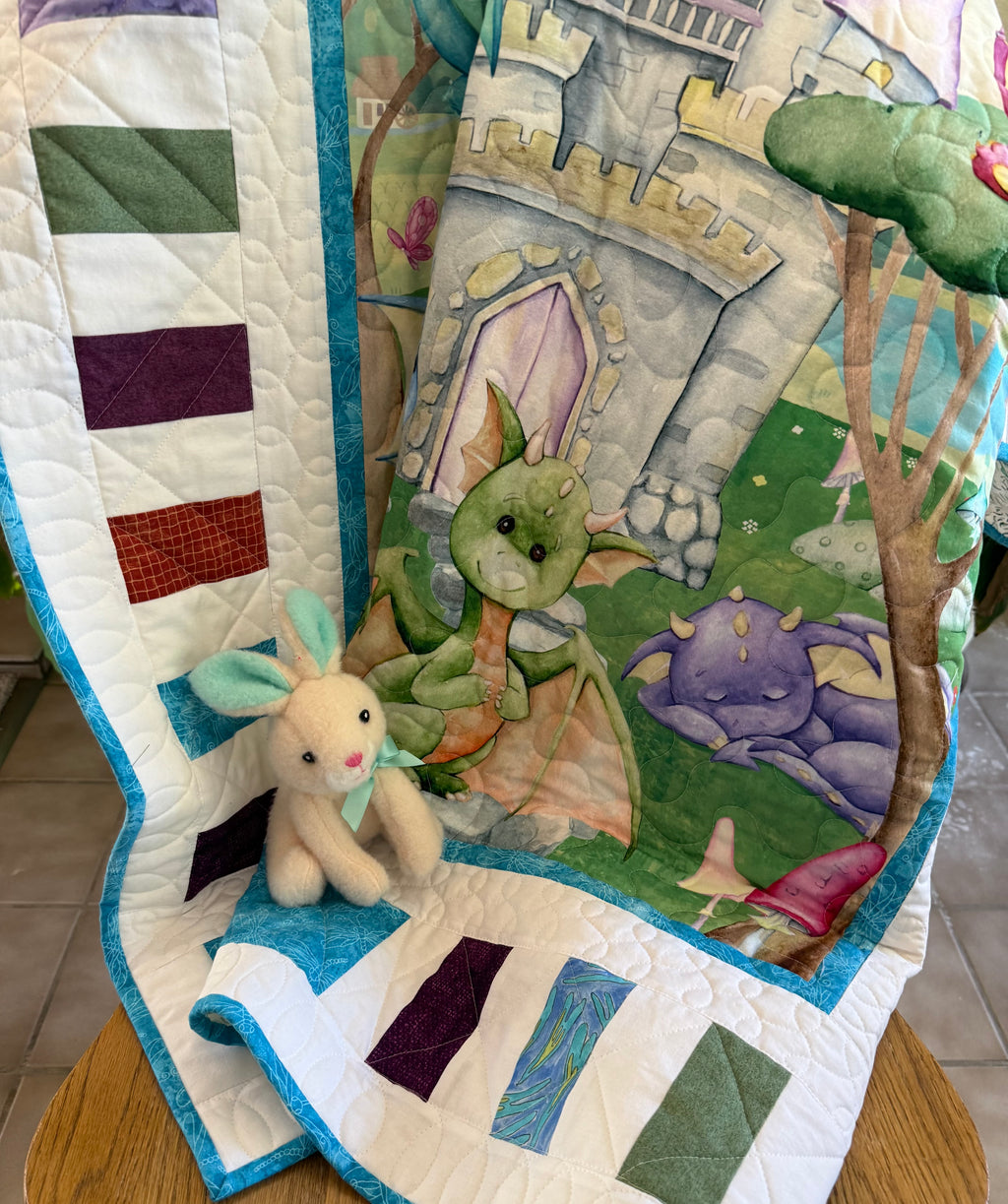 Handmade baby dragon quilt with colorful dragon design, soft cotton fabric, made by Oak & Thread Quilts