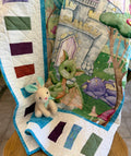 Handmade baby dragon quilt with colorful dragon design, soft cotton fabric, made by Oak & Thread Quilts