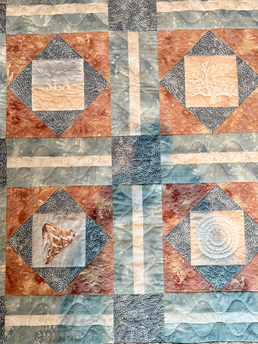Handmade quilt with sea shell blocks