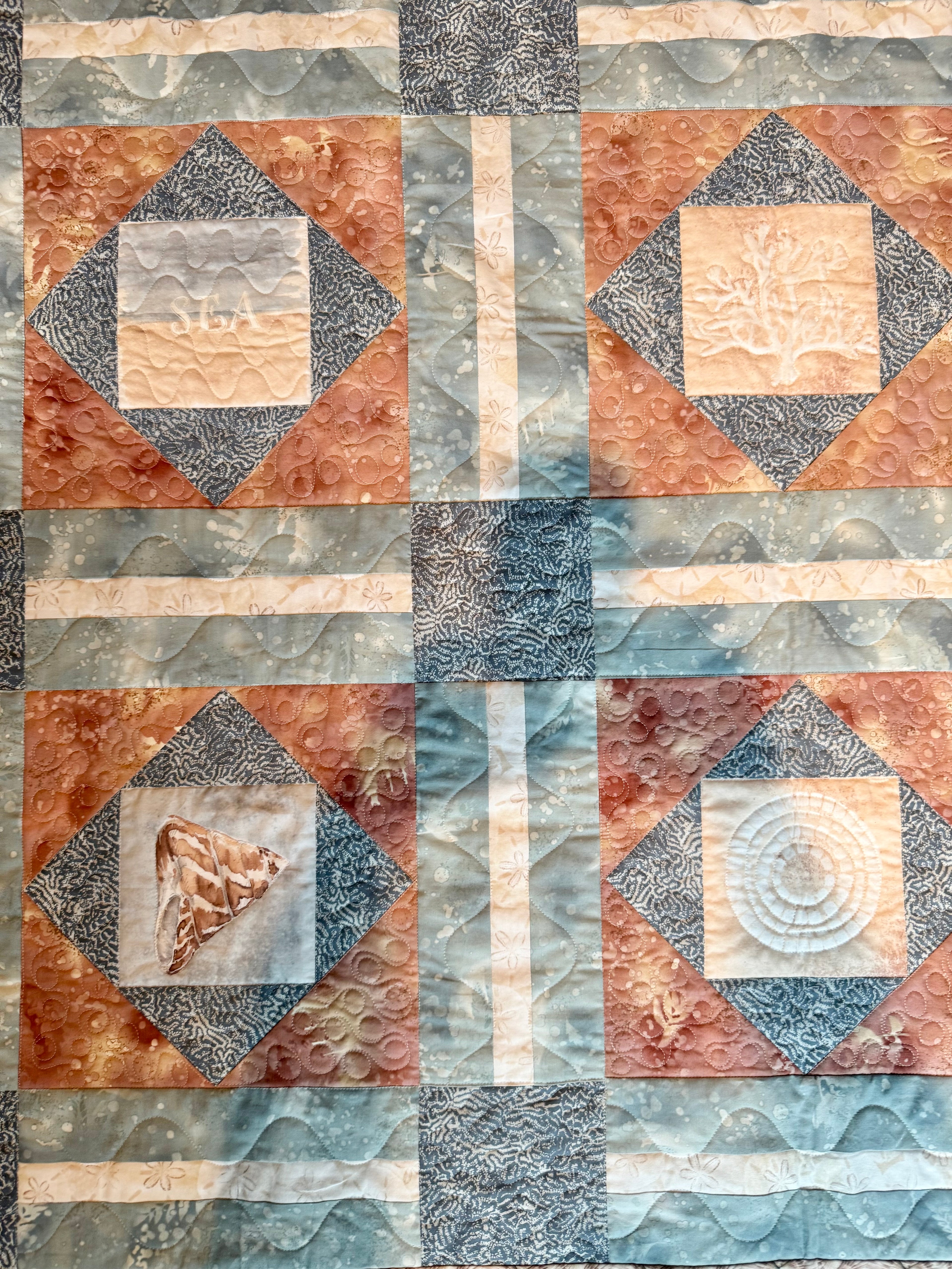 Handmade quilt with sea shell blocks