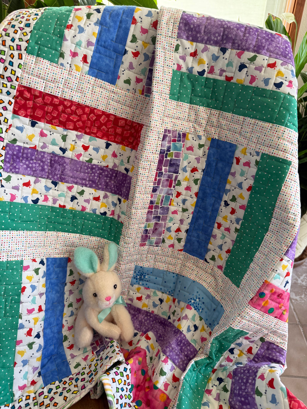 Colorful handmade baby quilt with chick fabric