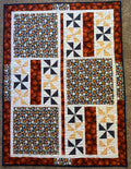 Handmade quilt featuring balls for various sports in navy blue and orange