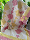 Handmade pink and yellow baby quilt in soft cotton, perfect baby gift, by Oak & Thread Quilts