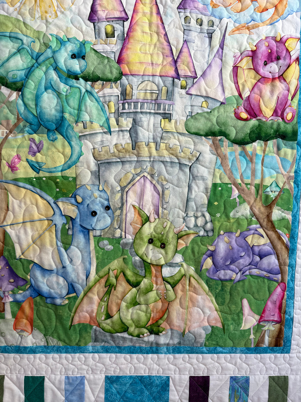 Handmade baby dragon quilt with colorful dragon design, soft cotton fabric, made by Oak & Thread Quilts