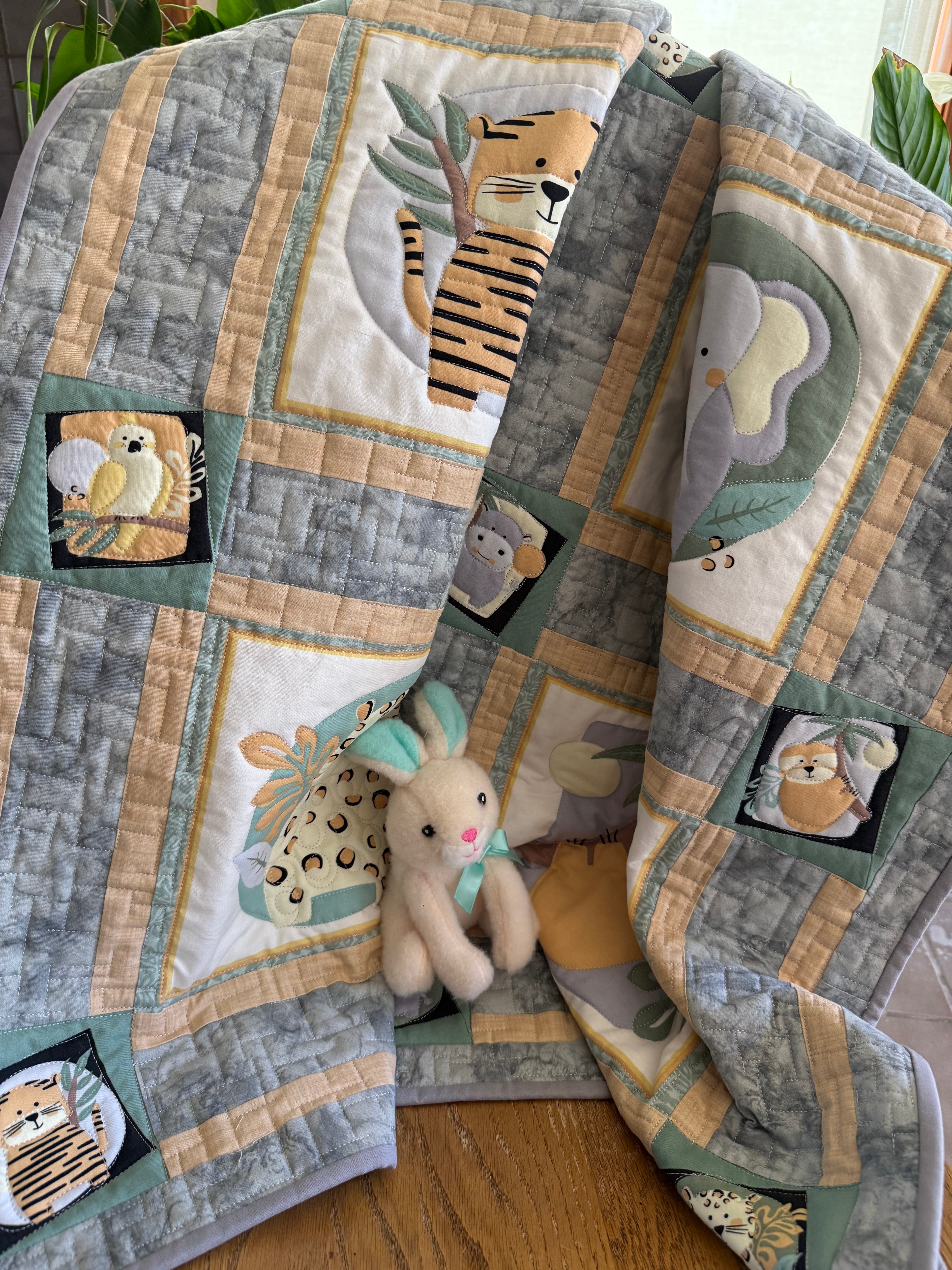 Handmade baby quilt with cute safari animals in green and beige