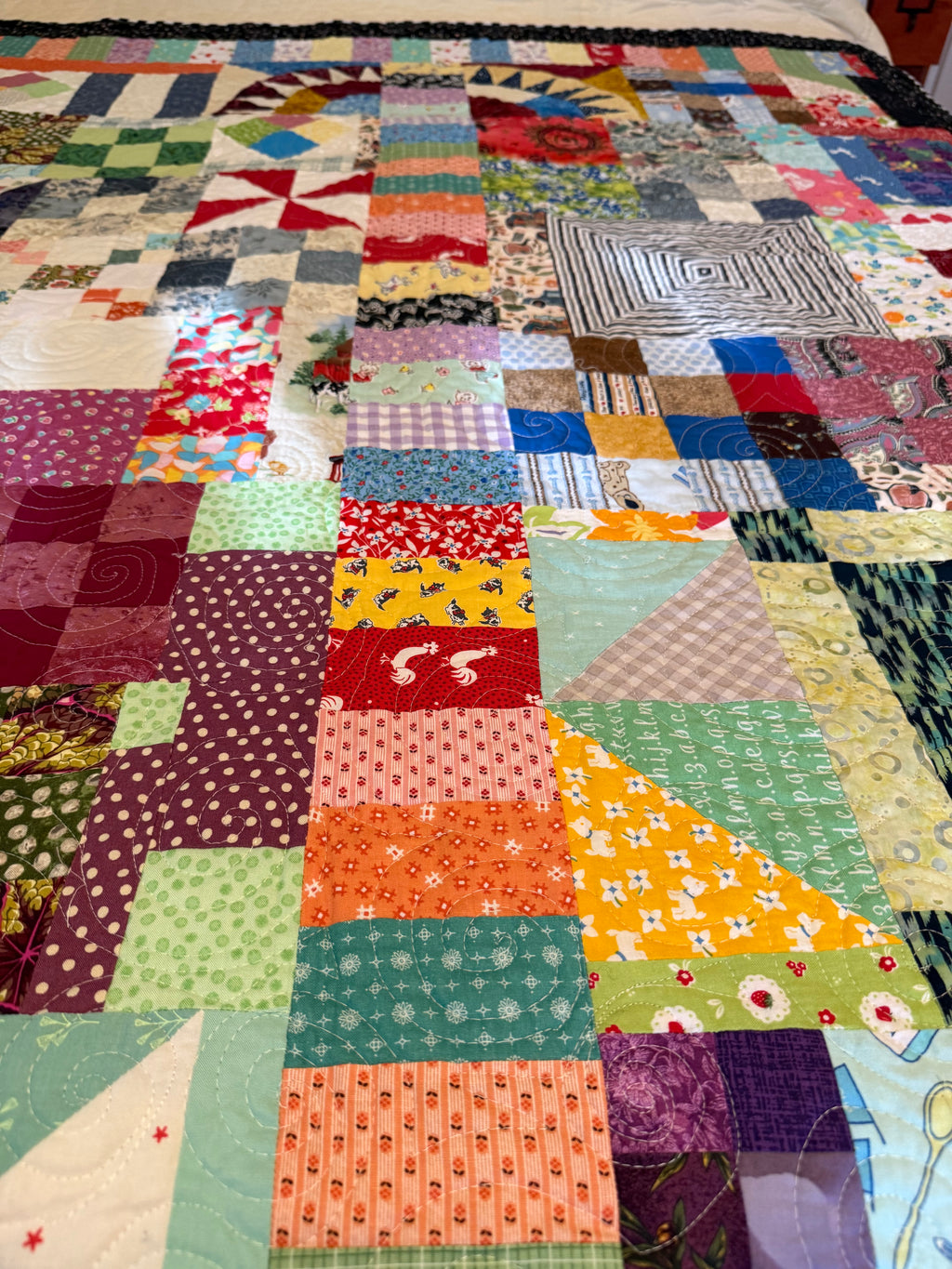 Close-up of colorful scrap fabric squares in bohemian patchwork quilt