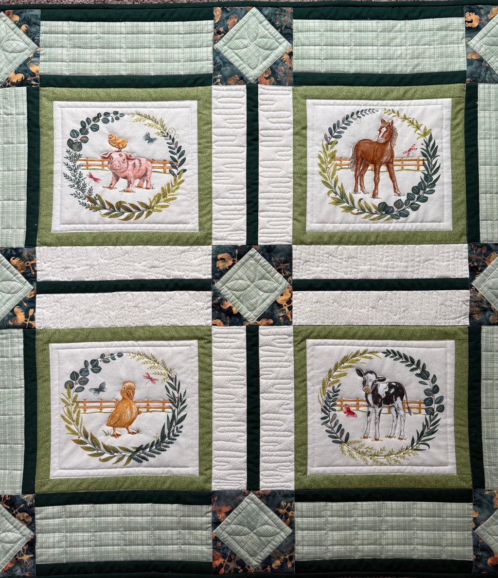 Handmade farm animal quilt with duckling and calf blocks