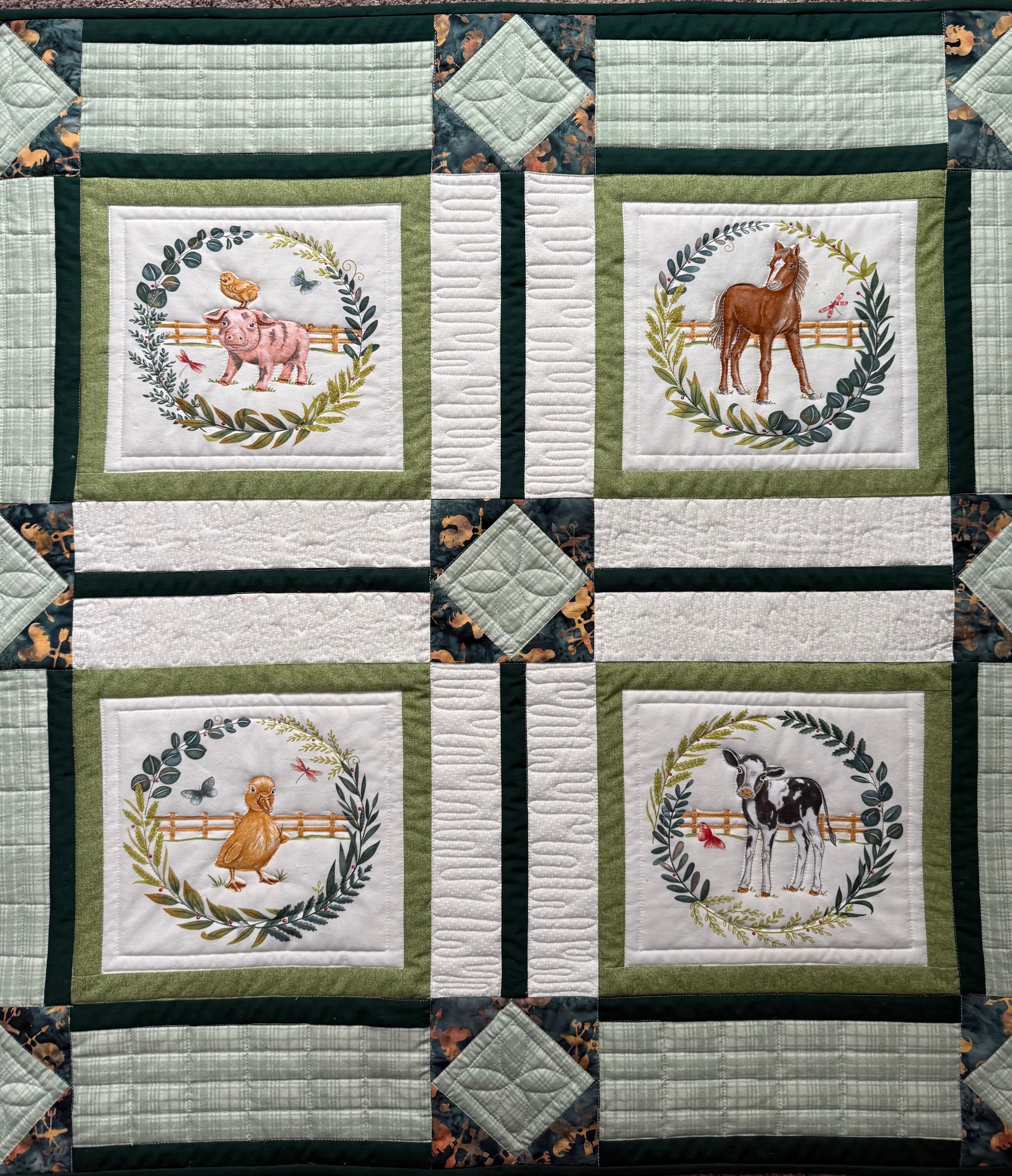 Handmade farm animal quilt with duckling and calf blocks