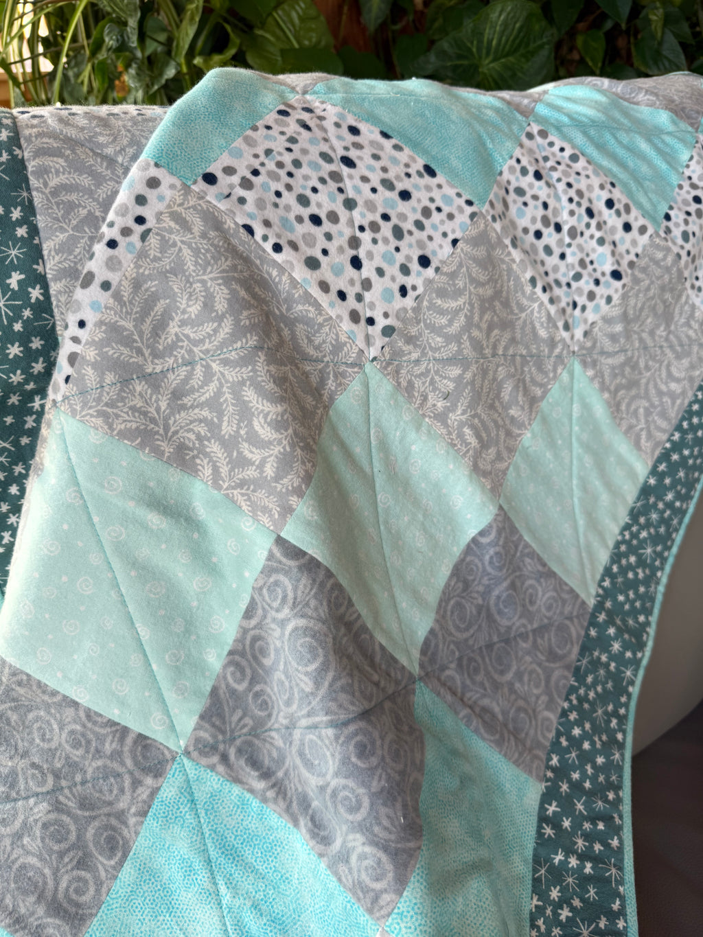 Handmade flannel scrap quilt in mixed prints, cozy and colorful, by Oak & Thread Quilts