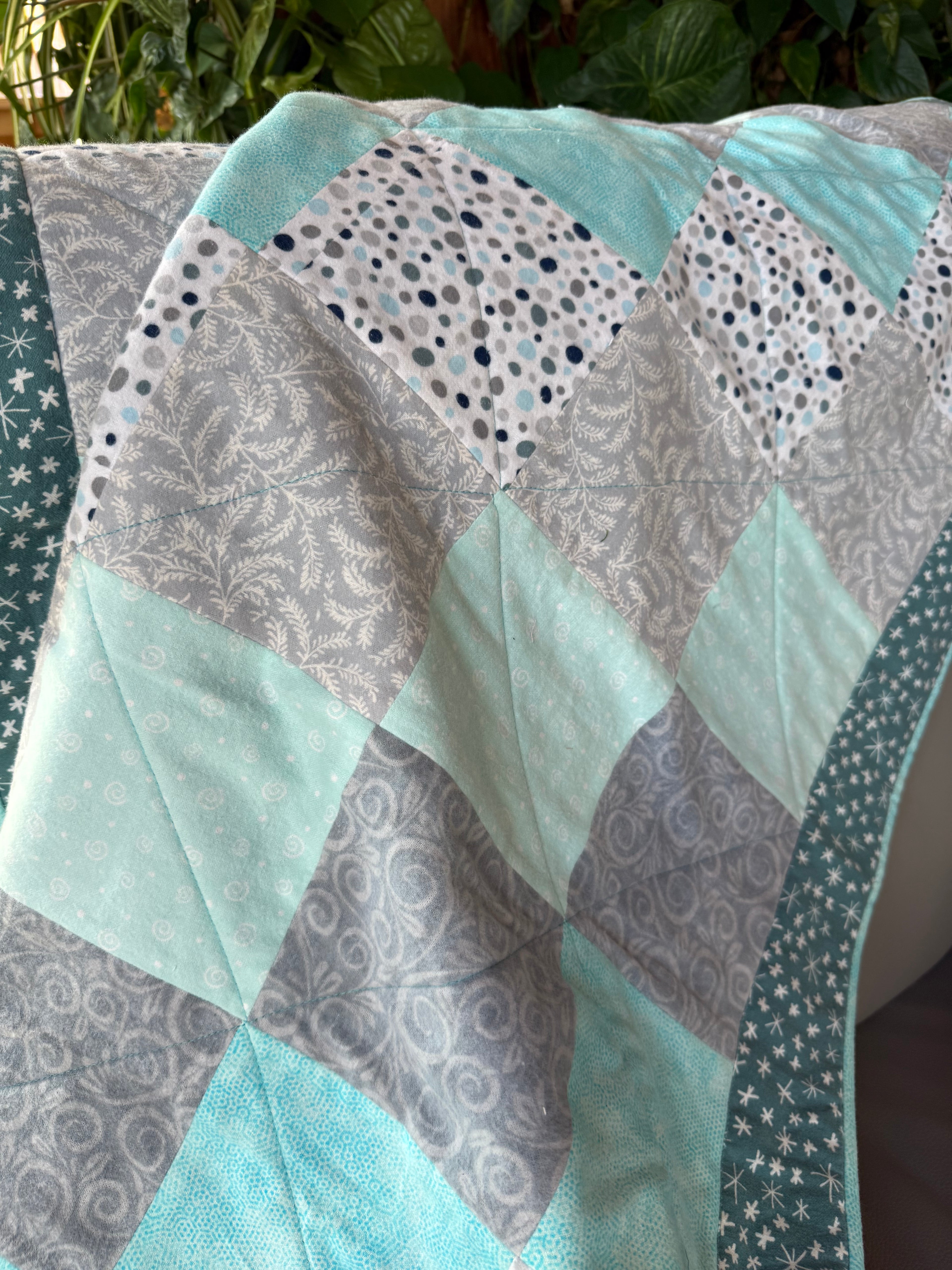 Handmade flannel scrap quilt in mixed prints, cozy and colorful, by Oak & Thread Quilts