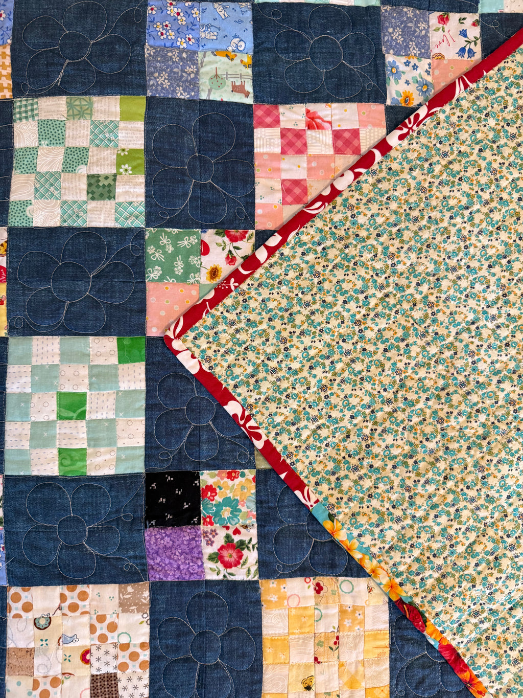 Handmade checkerboard quilt folded to show texture and backing and binding