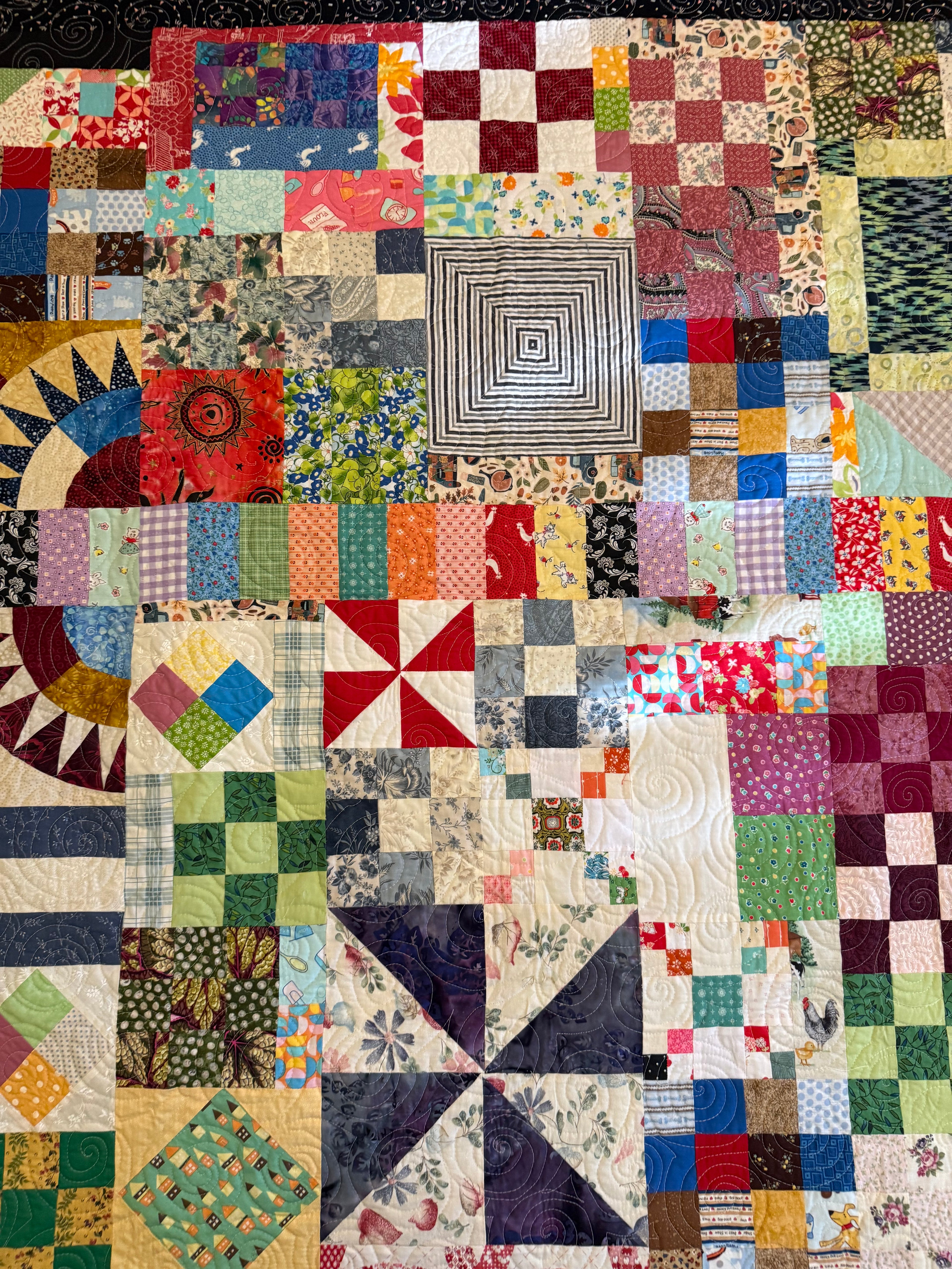 Handmade bohemian patchwork quilt laid flat showing full scrap design