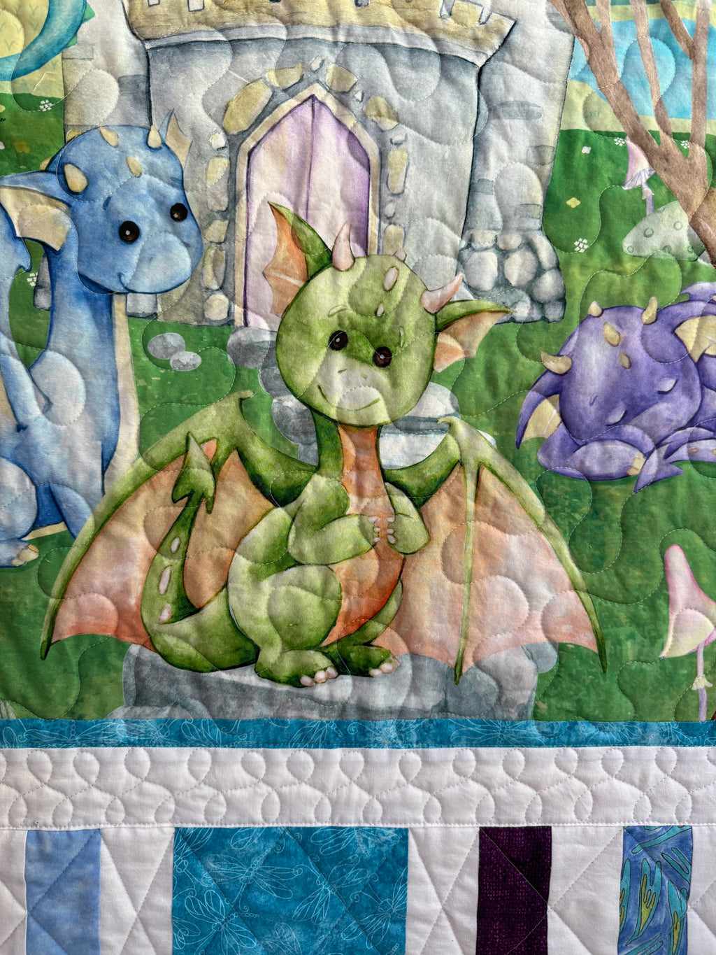 Handmade baby dragon quilt with colorful dragon design, soft cotton fabric, made by Oak & Thread Quilts