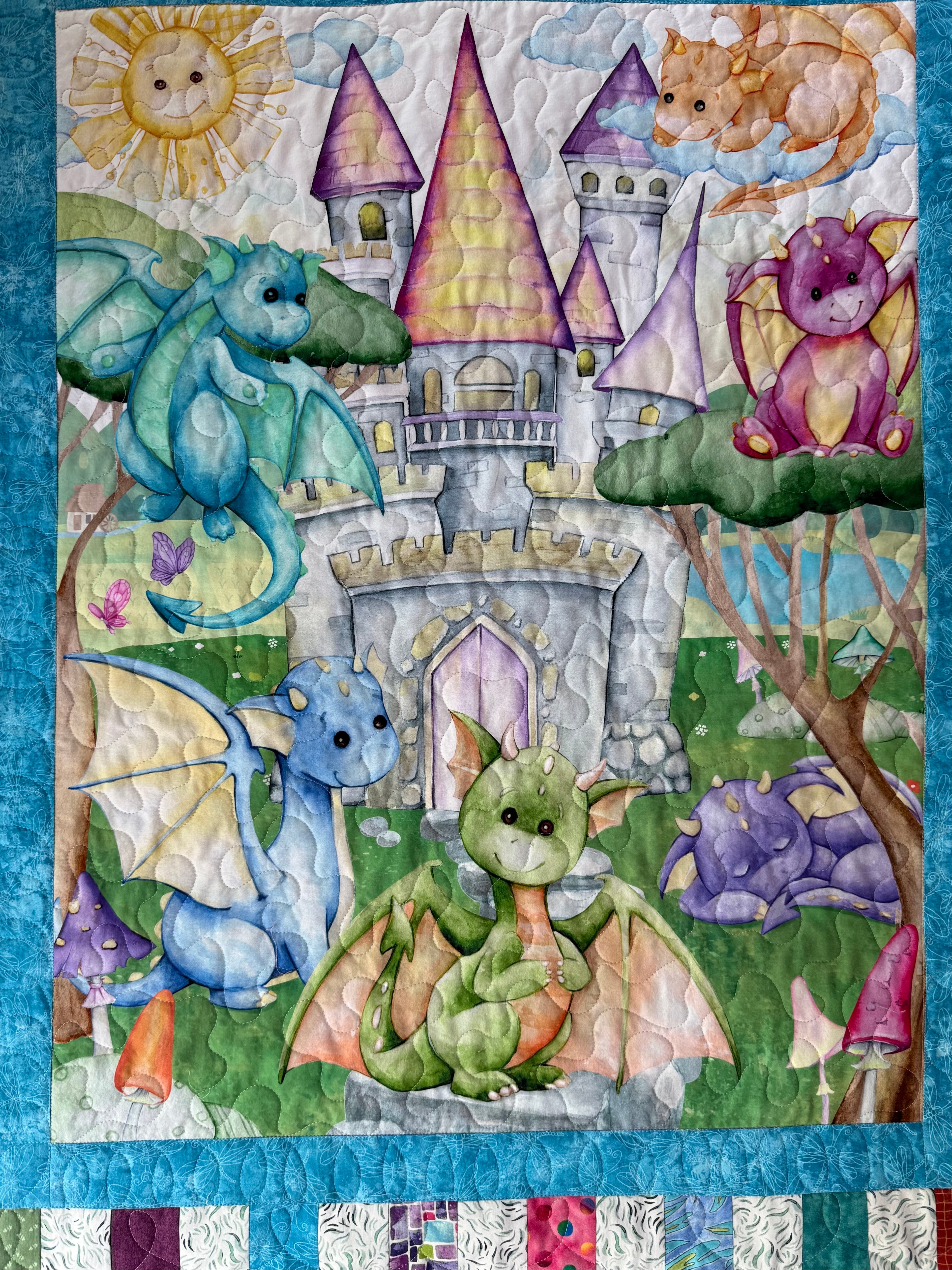Handmade baby quilt with baby dragons and colorful castle panel