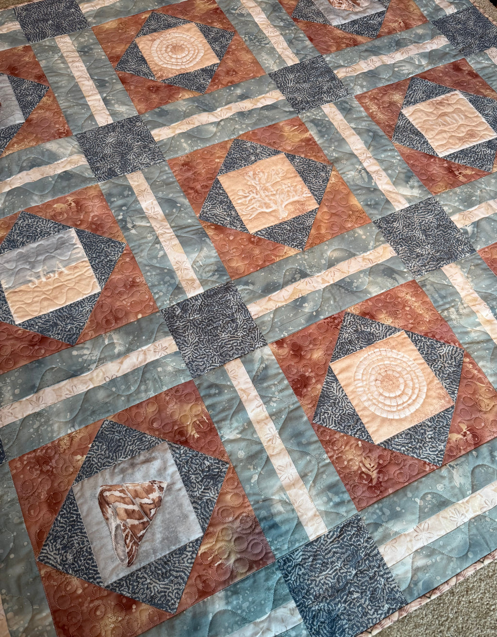 Handmade sea life quilt in blues and sand colors