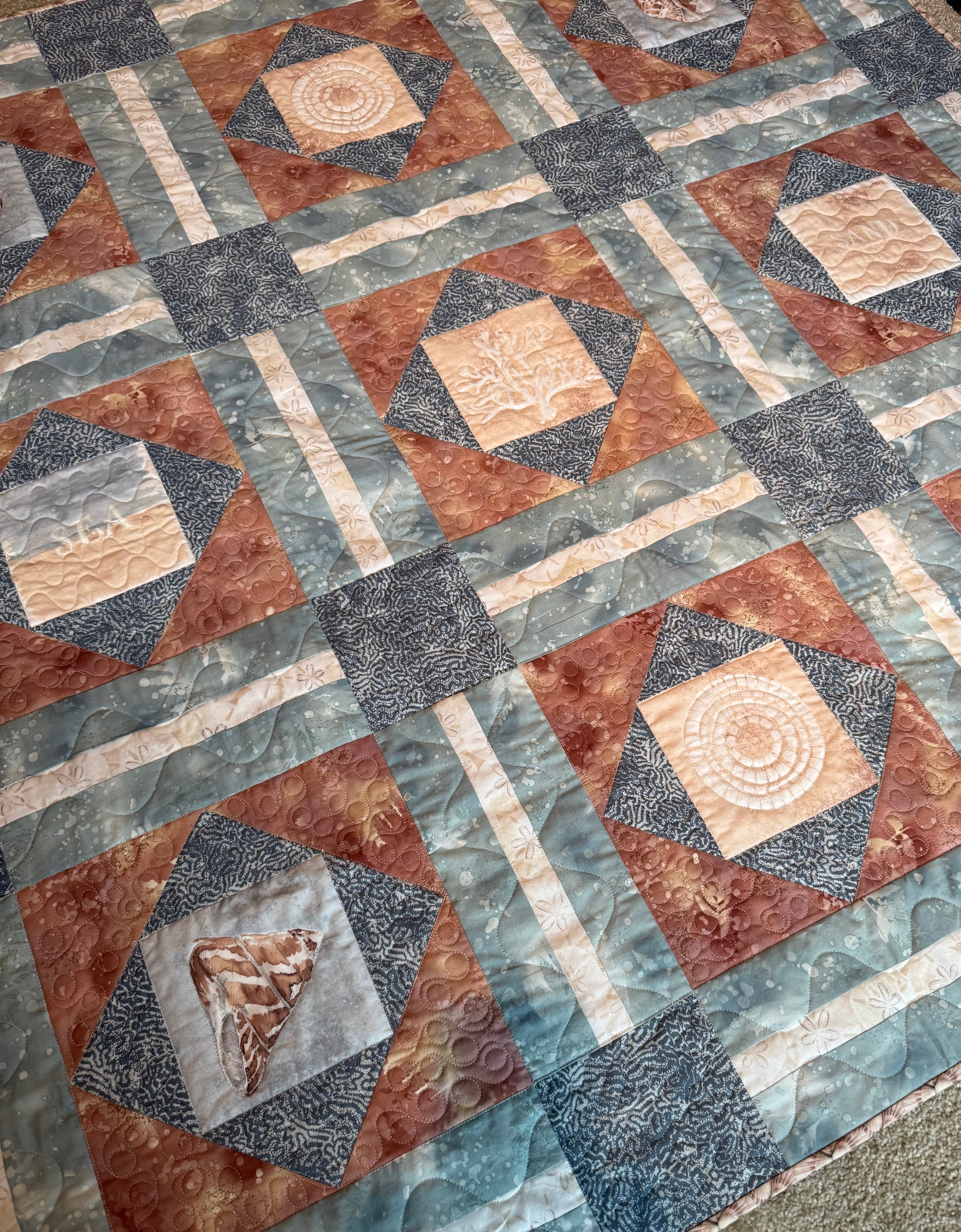 Handmade sea life quilt in blues and sand colors