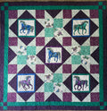 Handmade quilt featuring a repeating pattern of horses in shades of blue and purple. The quilt has a patchwork design with squares and diamonds in teal, white, and purple. The horses are detailed with decorative elements. 