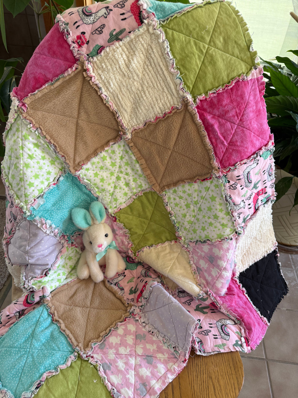 Colorful soft patchwork baby quilt with raw edges