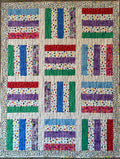 Colorful baby quilt using various strips of fabrics featuring baby chicks