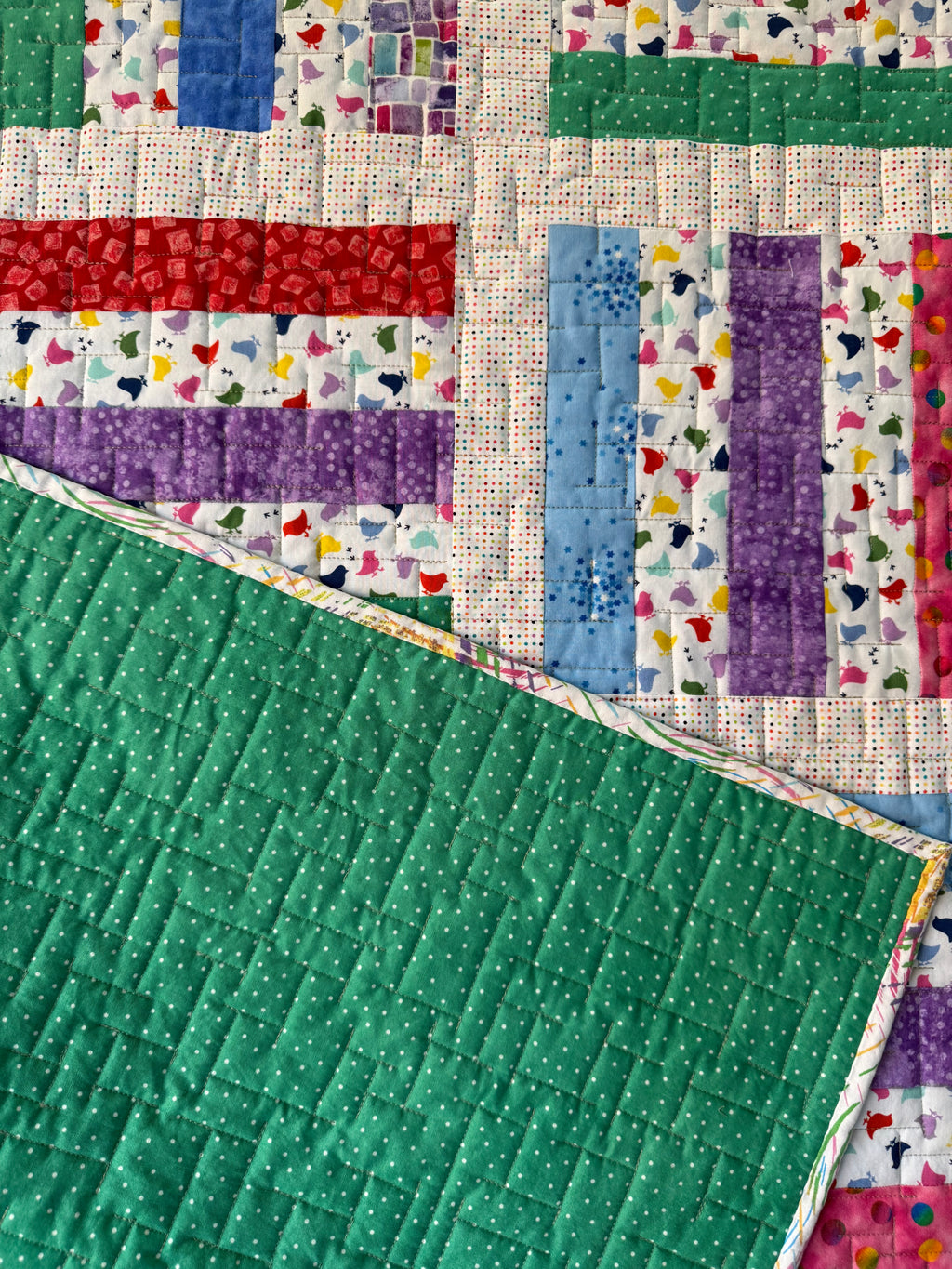 Handmade baby chick quilt showing close up of green dotted backing fabric 