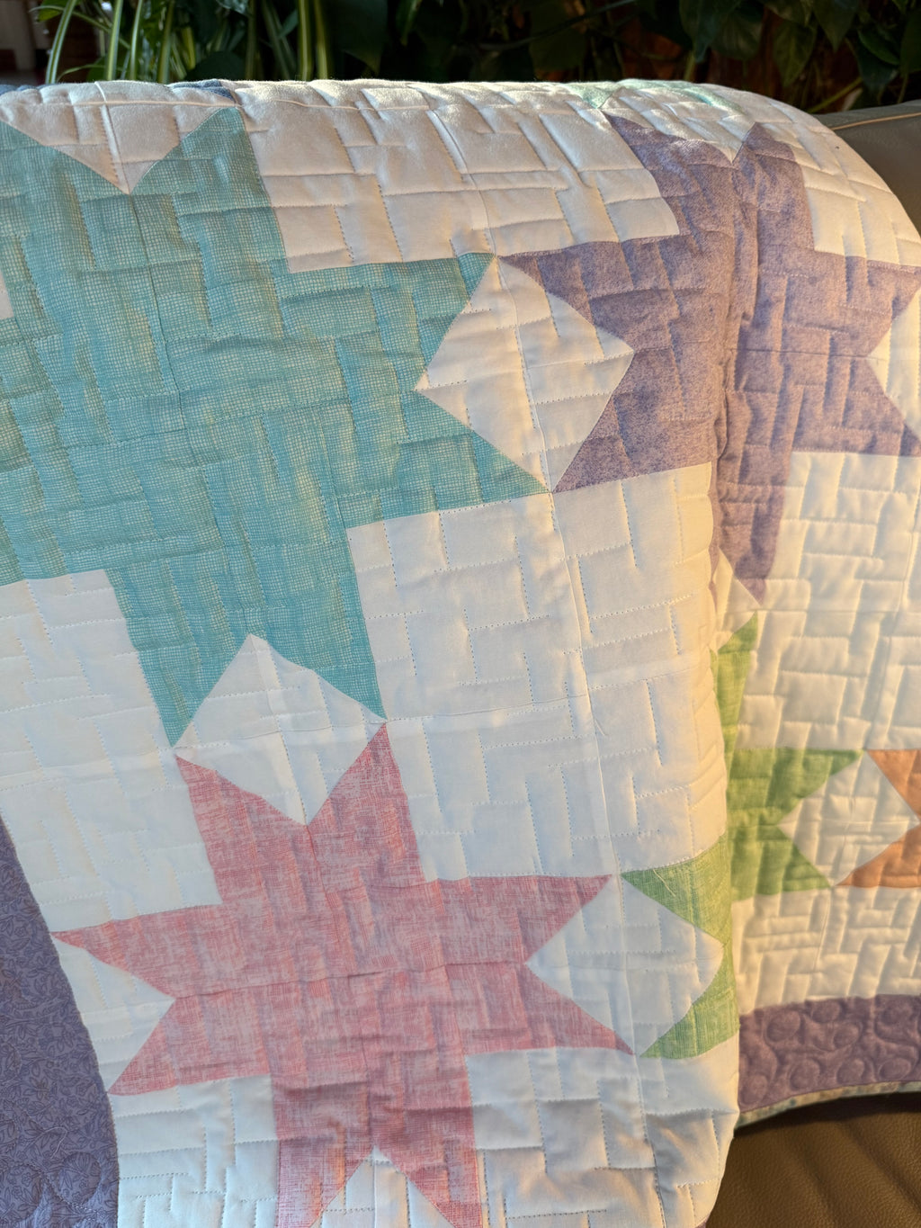 Handmade star baby quilt in soft pastel colors 