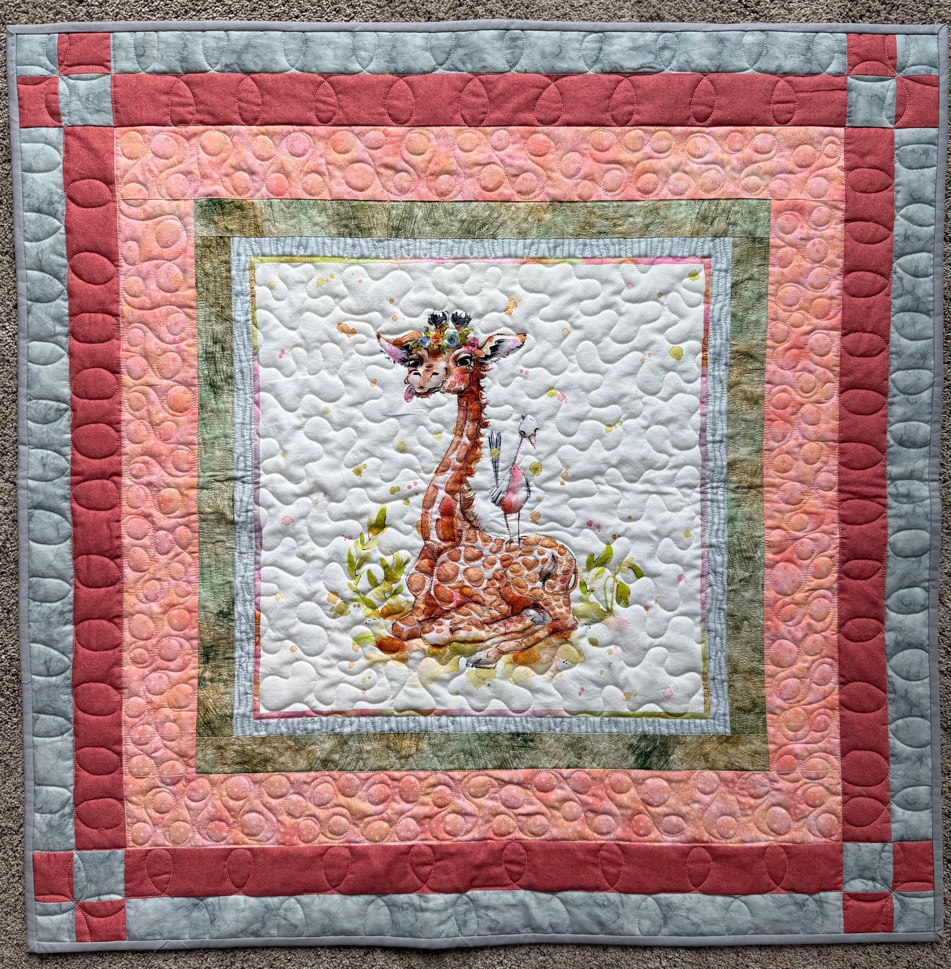 Handmade baby quilt with giraffe and orange and gray borders 