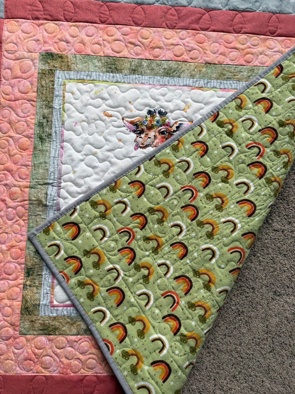 Giraffe baby quilt with green rainbow flannel backing