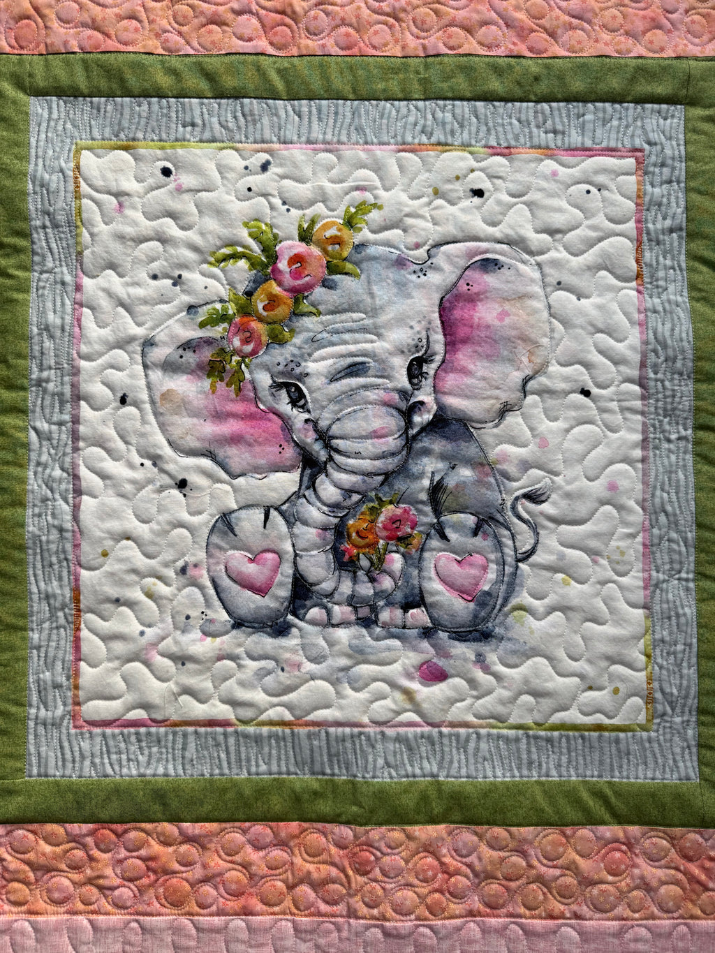 Close up of cute elephant on baby quilt showing quilting 