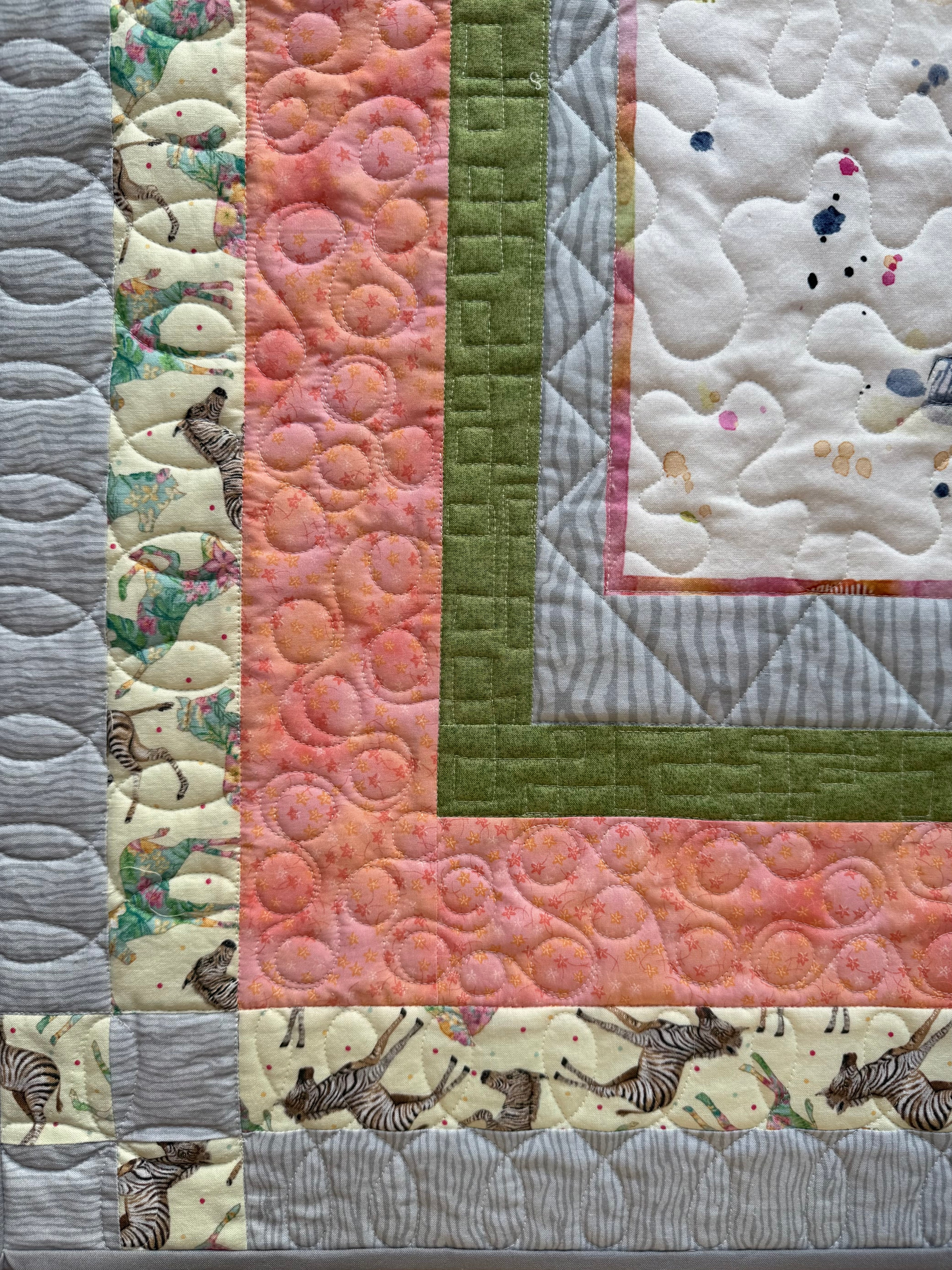 Handmade baby quilt showing close up of zebra borders and quilting 