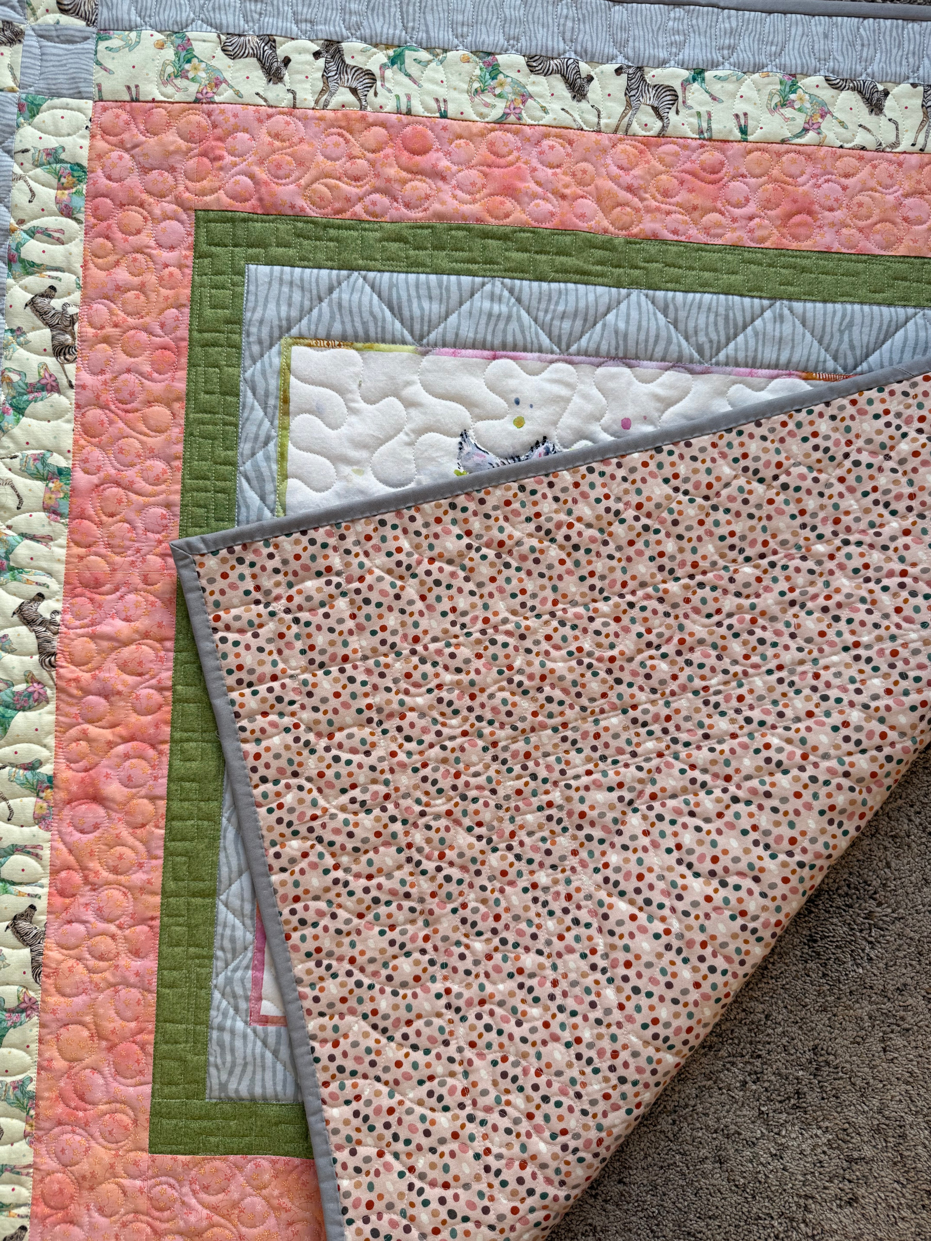 Handmade zebra quilt showing peach dotted backing fabric 