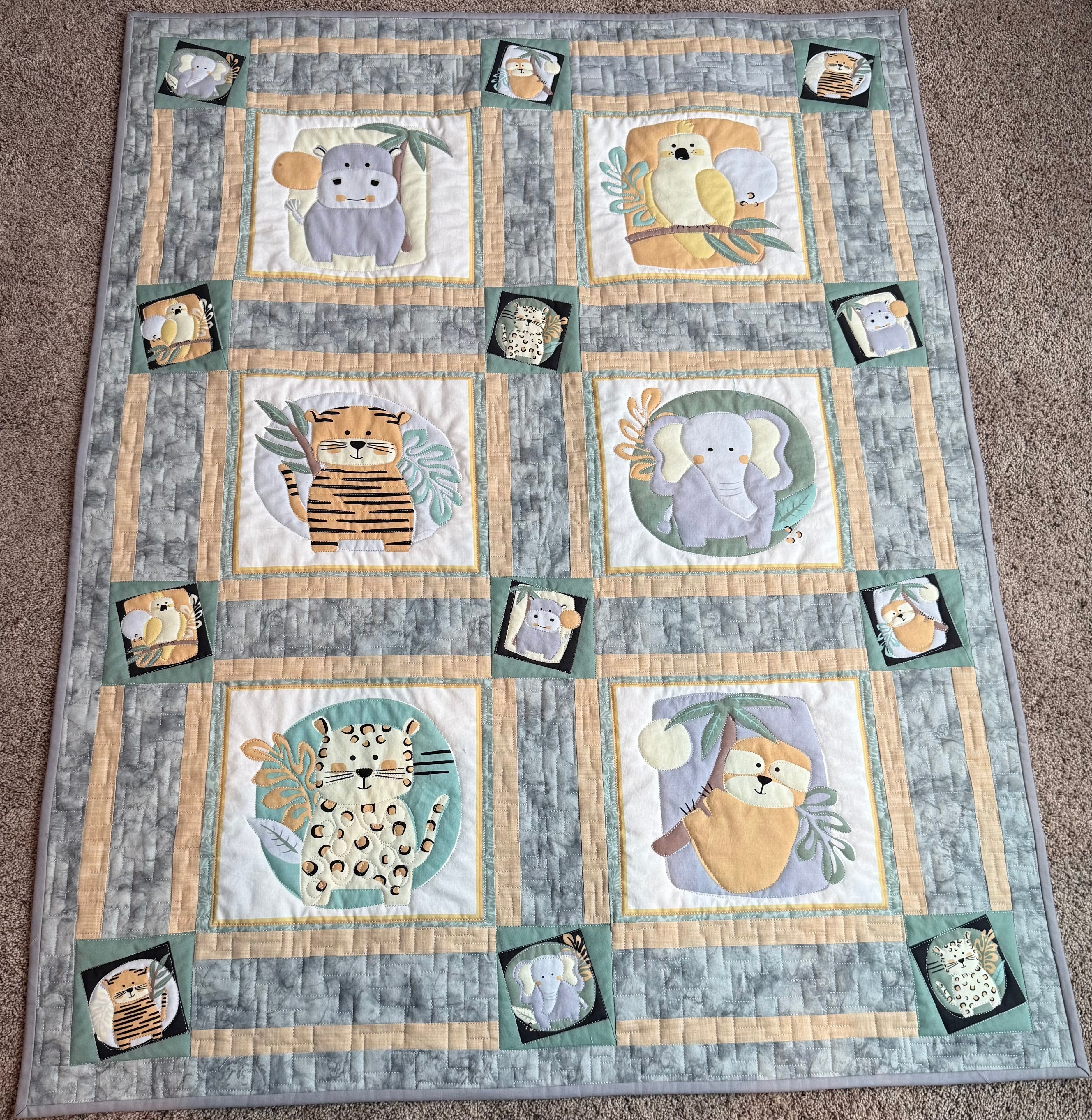 Handmade safari baby quilt in gray and green
