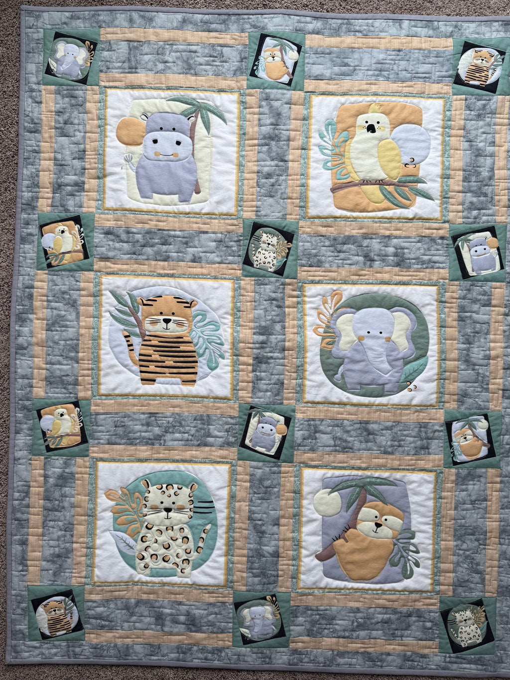Handmade baby quilt with safari jungle animals
