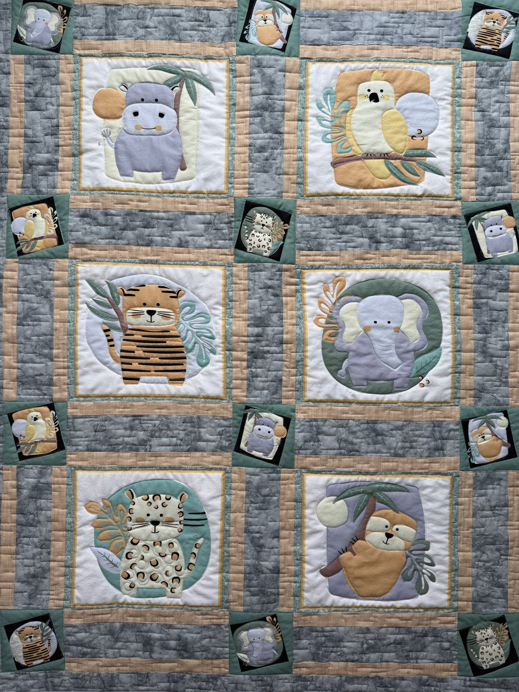 Handmade jungle animal baby quilt in green and gray fabrics 