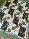 Handmade dinosaur quilt in blues and greens
